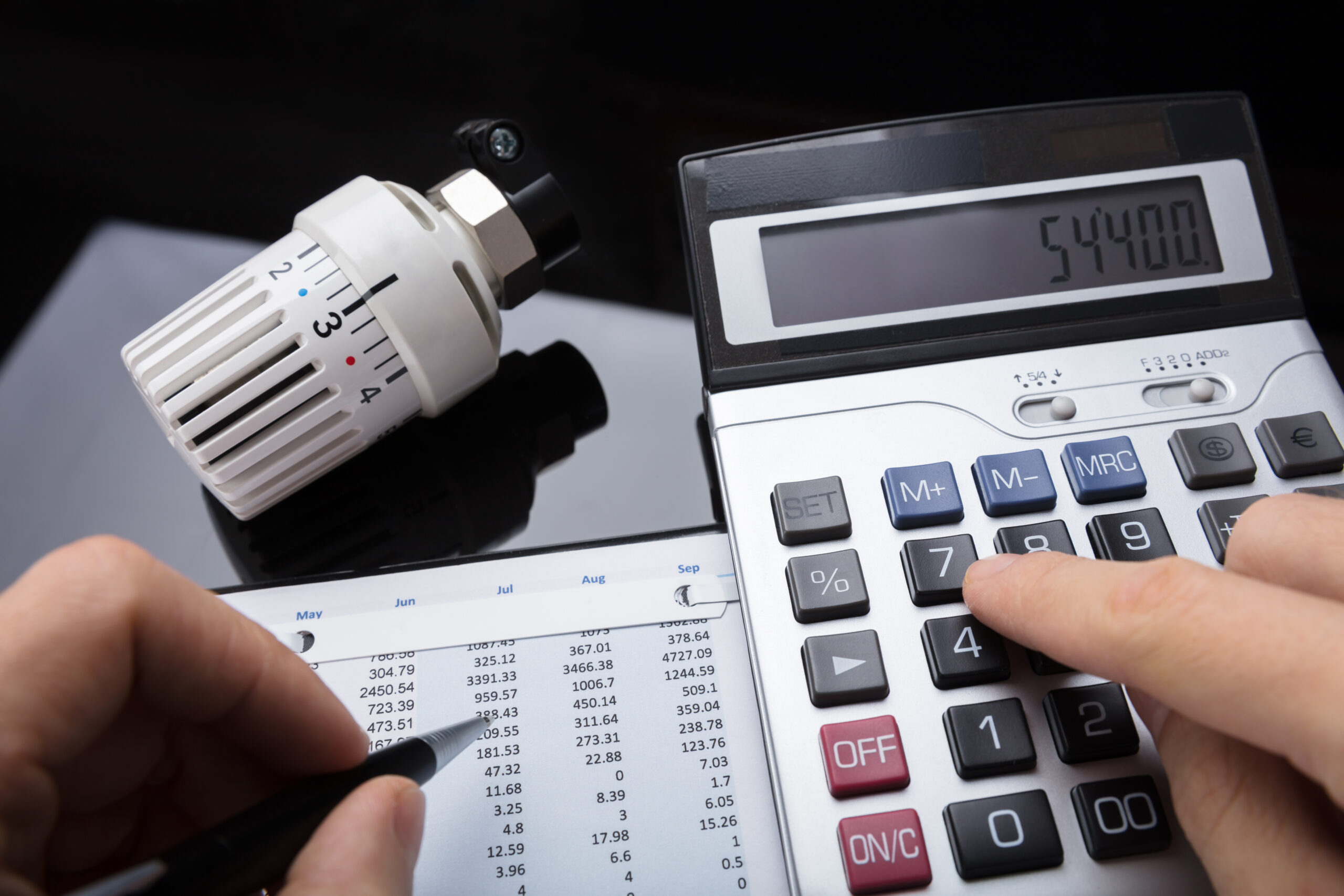 Close Up Of A Human Hand Calculating Financial Report