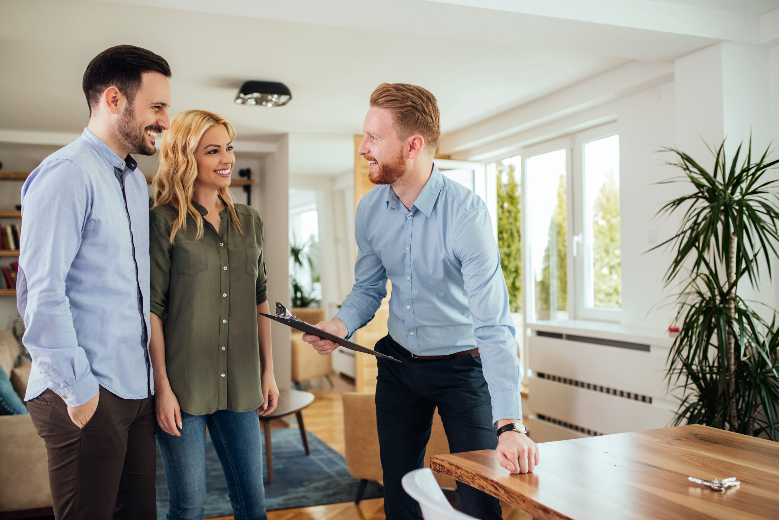 Happy Couple In Meeting With A Estate Agent